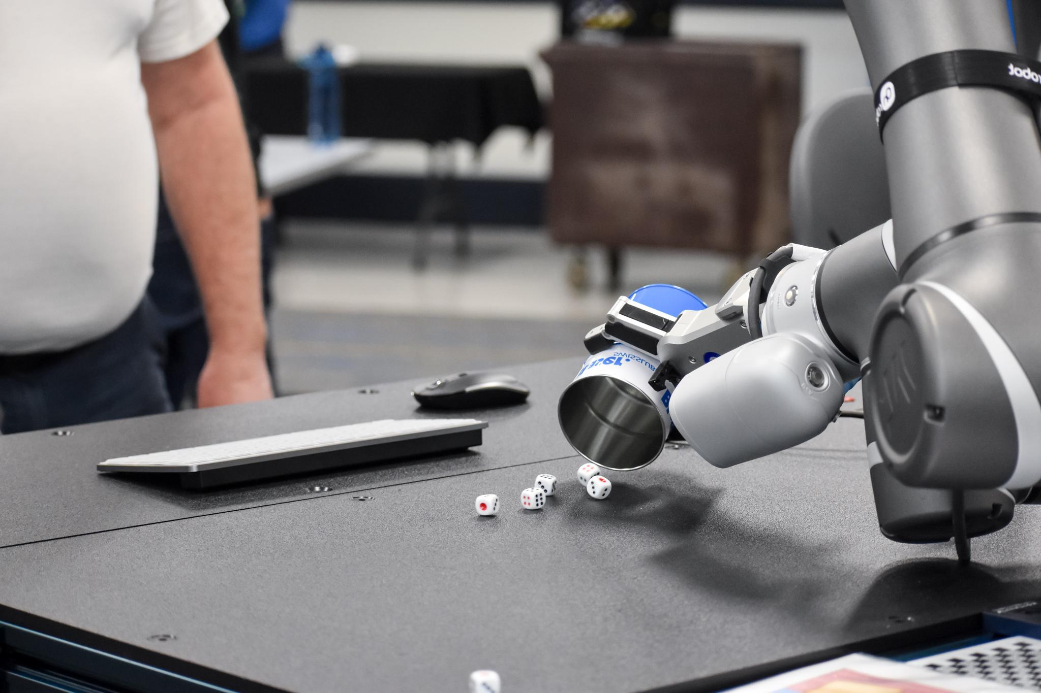 Robotic arm playing a round of dice.