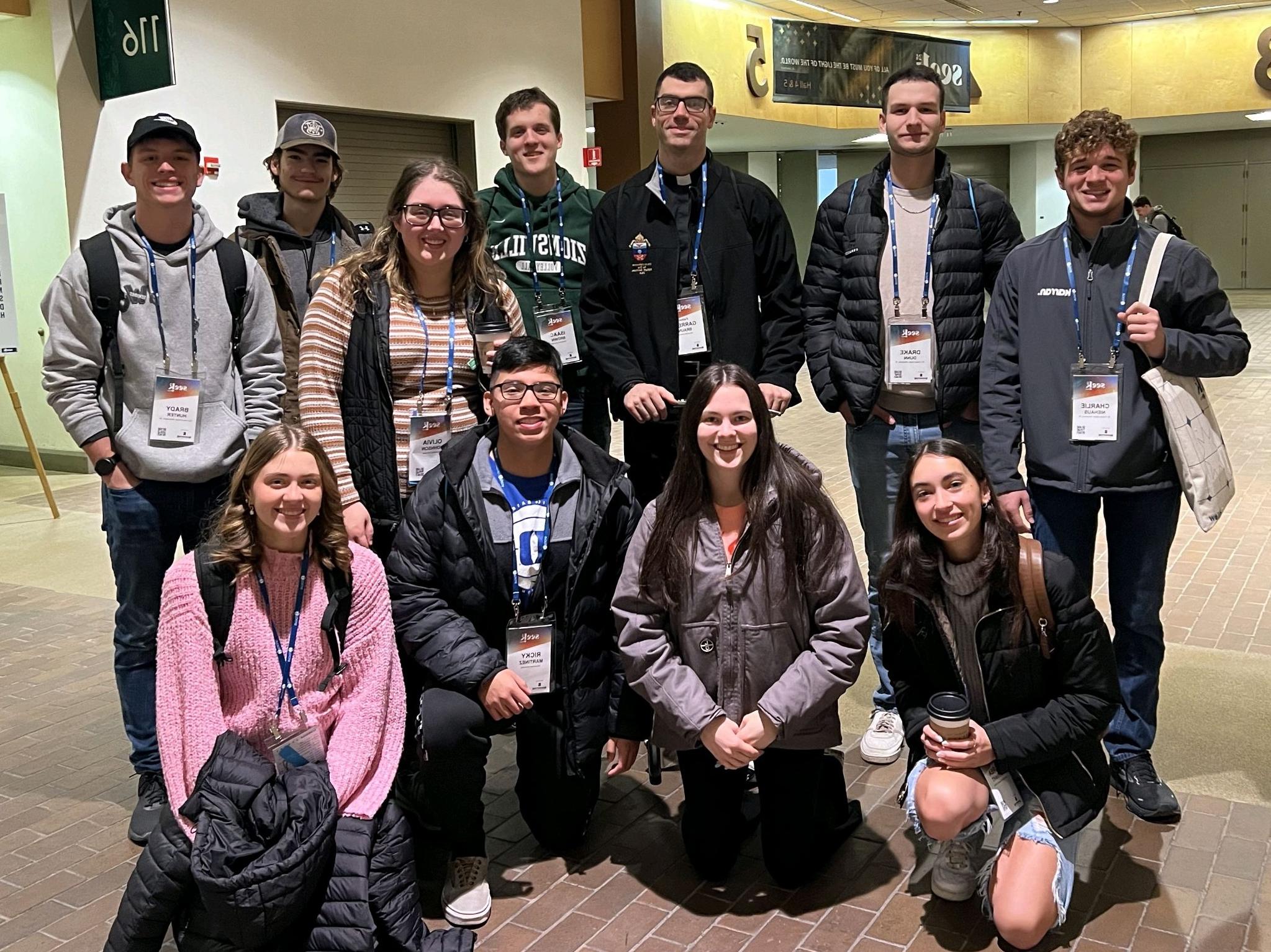 Blazer Catholic members posing for a photo at a conference