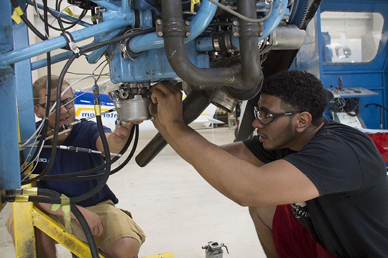 student working on plane parts